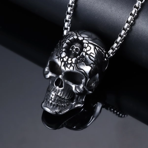 Gothic stainless steel necklace featuring large and small skull head pendant on black background
