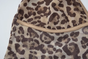 Close-up of leopard print mesh fabric with breathable texture and fine stitching detail