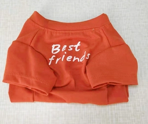 Detailed view of red cotton pet T-shirt with white Best friends printed lettering