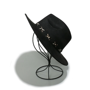 Detail of black suede fedora hat with cross-stitch decorative band on metal display stand
