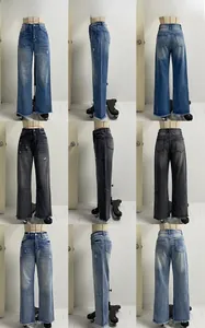 Detail view of high waist wide leg jeans with distressed frayed hems and whiskers