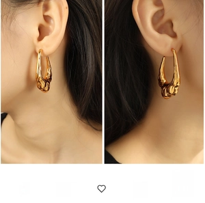 Detail of 18K gold plated lava-style hollow earrings with irregular melting metal texture