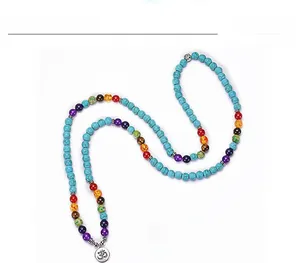 Detail of 108 turquoise beads bracelet with seven chakra stones and silver Om pendant