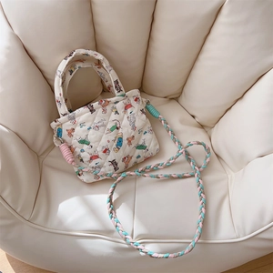 Quilted white cotton mini bag with colorful cartoon dog prints and braided rope strap