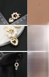 Detail showing natural freshwater pearls and heart-shaped zircon on gold-plated earrings