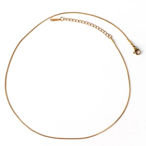 Detail view of a gold-plated stainless steel chain with lobster clasp on white background