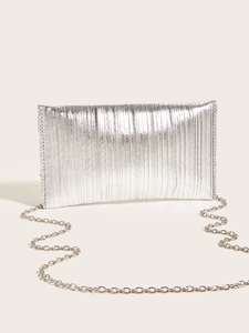 Close-up of silver evening clutch bag featuring vertical pleated metallic texture and chain