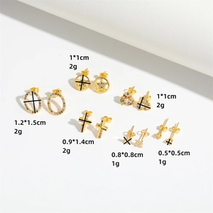 Golden stud earrings with colorful zircon in cross and star shapes on white background
