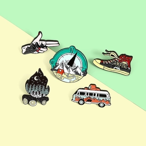 5-piece outdoor camping enamel pins set featuring a compass, hiking shoes, and camper van
