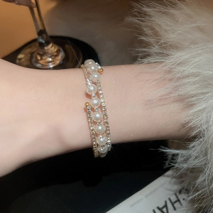 Close-up of double-layered pearl and rhinestone bracelet with gold-plated finish