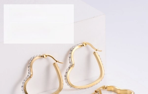Macro detail of gold-plated heart hoop earrings with sparkling pavé cubic zirconia