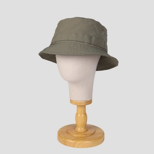 Detail of army green nylon sun hat with tactical side strap and metal ventilation eyelets
