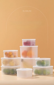 Stackable plastic storage bins with lids for organizing fruits in a kitchen refrigerator