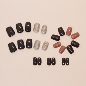 Flat lay of brown and pink glitter press-on nails in short square shape on beige background