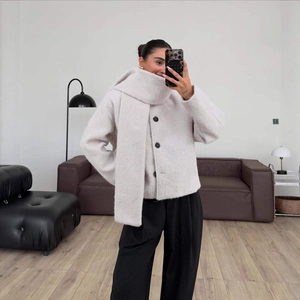 Short cream boucle wool coat with scarf and black buttons in a minimalist mirror selfie