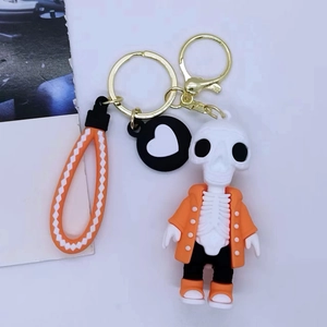 Creative cartoon skull keychain with orange jacket and orange-white braided wrist strap