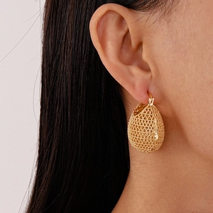 French style gold mesh geometric hoop earrings with hollow drop shape texture on model