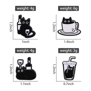 Macro shot showing dimensions and weight of playful black cat enamel pins and badges