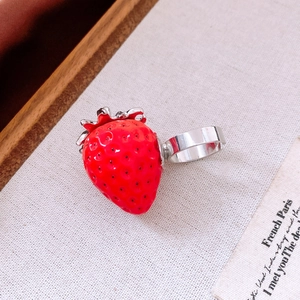Detailed macro view of the strawberry pendant necklace with red finish and silver stem