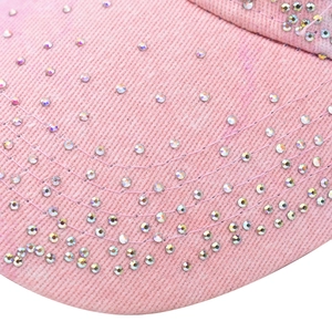 Macro detail of pink denim baseball cap with sparkling colorful rhinestones and stitching