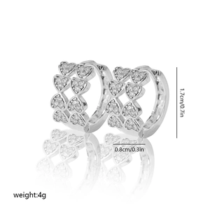Macro detail of silver heart hoop earrings featuring double rows of sparkling pave zircons
