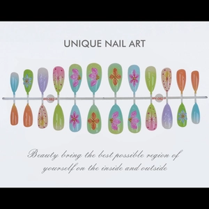 Detail of almond 3D flower press-on nails with colorful gradients and gold accents