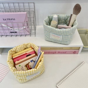Detailed view of quilted plaid fabric storage baskets in yellow and blue colors
