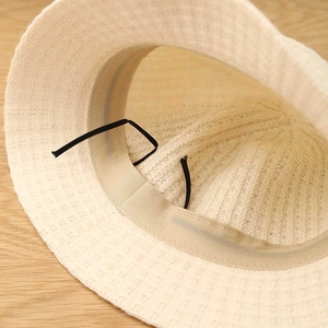 Detail view of the breathable wool bucket hat interior with adjustable sizing strings