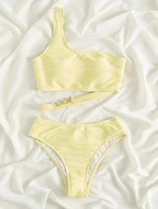 Detailed view of yellow ribbed bikini with single shoulder strap and gold ring chain link