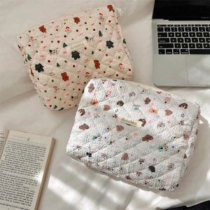 Detailed view of quilted cotton cosmetic bags featuring bear and puppy patterns
