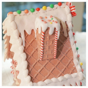 Macro shot of faux gingerbread house roof with realistic icing and colorful candy details