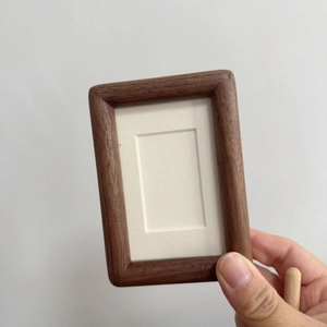 Miniature solid walnut wood photo frame with rounded corners and cream paper matting