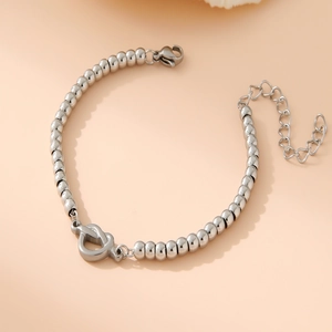 Close-up of silver bead bracelet with heart charm and adjustable lobster clasp closure