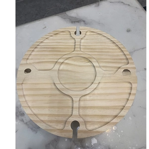 Top view of a round wooden snack tray with dividers and built-in wine glass holders