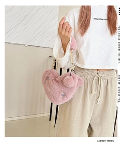 Detail of pink heart plush bag with chain strap and cute rainbow rabbit embroidery