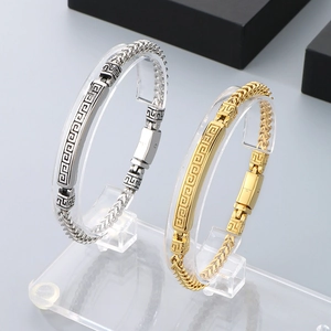Detail of gold and silver stainless steel bracelets with cloud pattern on acrylic stands