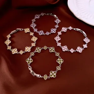 Elegant four-leaf clover zircon bracelets in multiple colors on a silk background