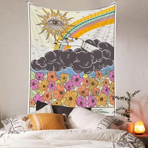 Detail of bohemian sun and hand tapestry hanging on a bedroom wall with floral patterns