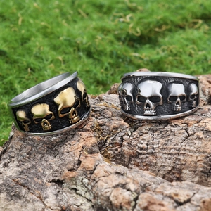 Gothic punk skull rings in vintage silver and gold black finish on rustic wood