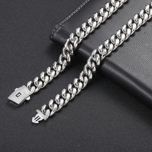 Detail of silver Cuban link chain featuring a sparkling pavé zircon square clasp design