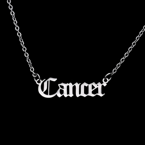 Macro detail of gothic style Cancer zodiac letter pendant in polished silver stainless steel