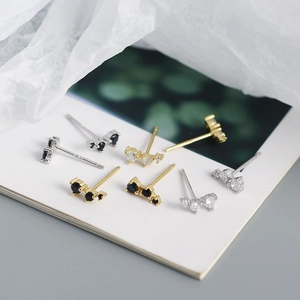Macro shot of S925 sterling silver geometric earrings with gold and silver crystal settings