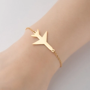 Elegant gold stainless steel bracelet featuring a minimalist airplane pendant on a fine link chain