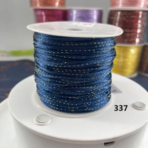 Detailed view of dark blue braided cord with gold glitter for DIY jewelry making