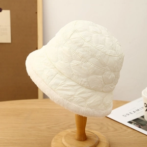 Close-up of winter quilted bucket hat in cream white with cozy faux fur trim detail