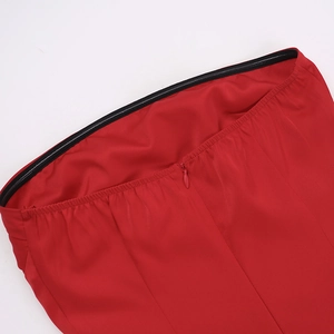 Detailed view of invisible zipper and seam stitching on a red satin dress