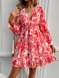 Detail of red floral print dress with deep V-neck and ruffled long sleeves