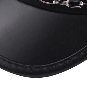 Detailed close-up of a black PU leather military cap featuring a silver metal chain accent