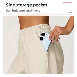 Detail of high waist joggers featuring a deep side pocket for smartphone storage