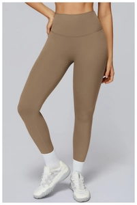 Detail view of high-waist yoga leggings in brown matte high-elasticity fabric